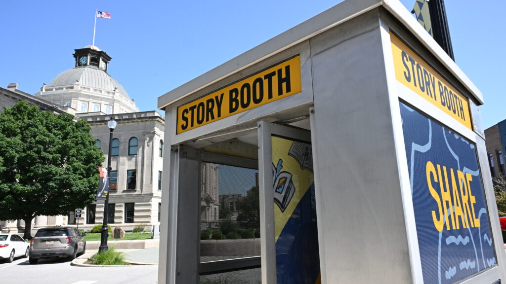 A phone booth located outside a historic building