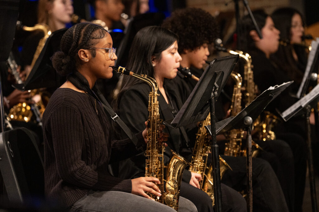 Close up of students playing saxophones