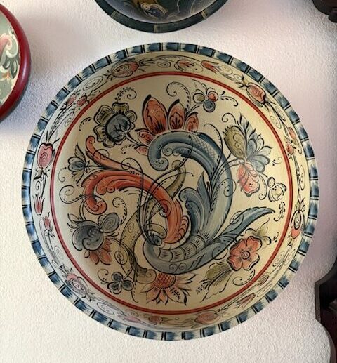 A hand painted bowl with intricate floral designs