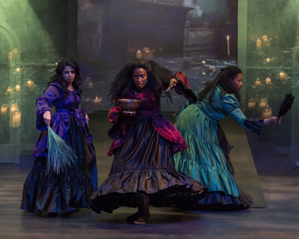 Three actors as witches onstage for Macbeth