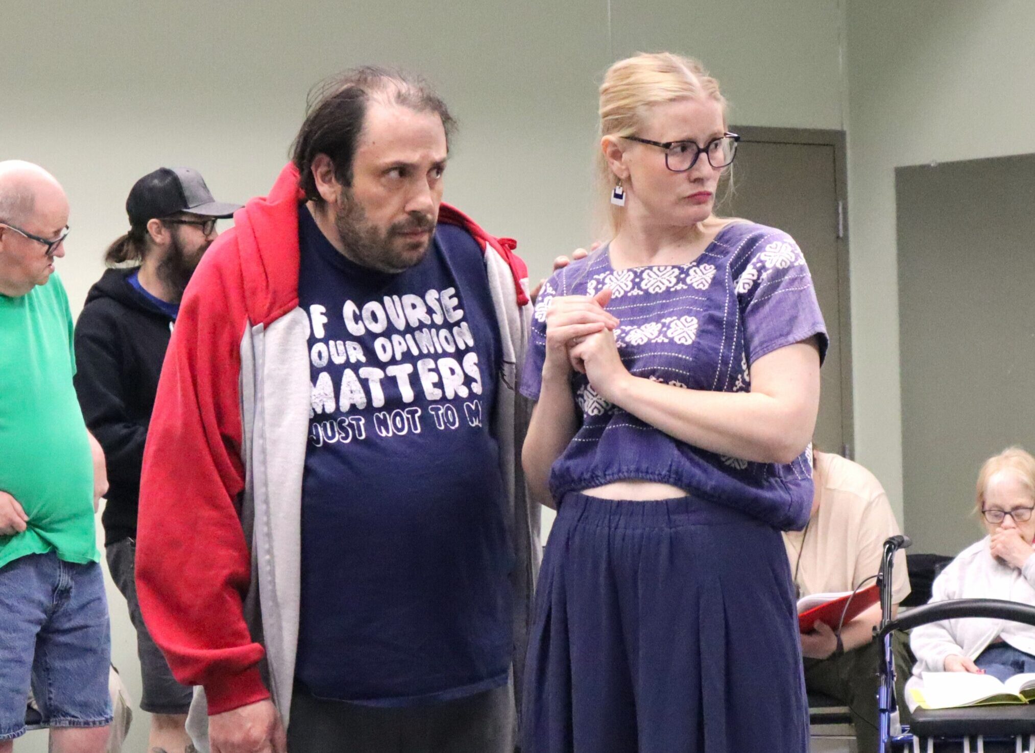 Two actors staring with surprised facial expressions.