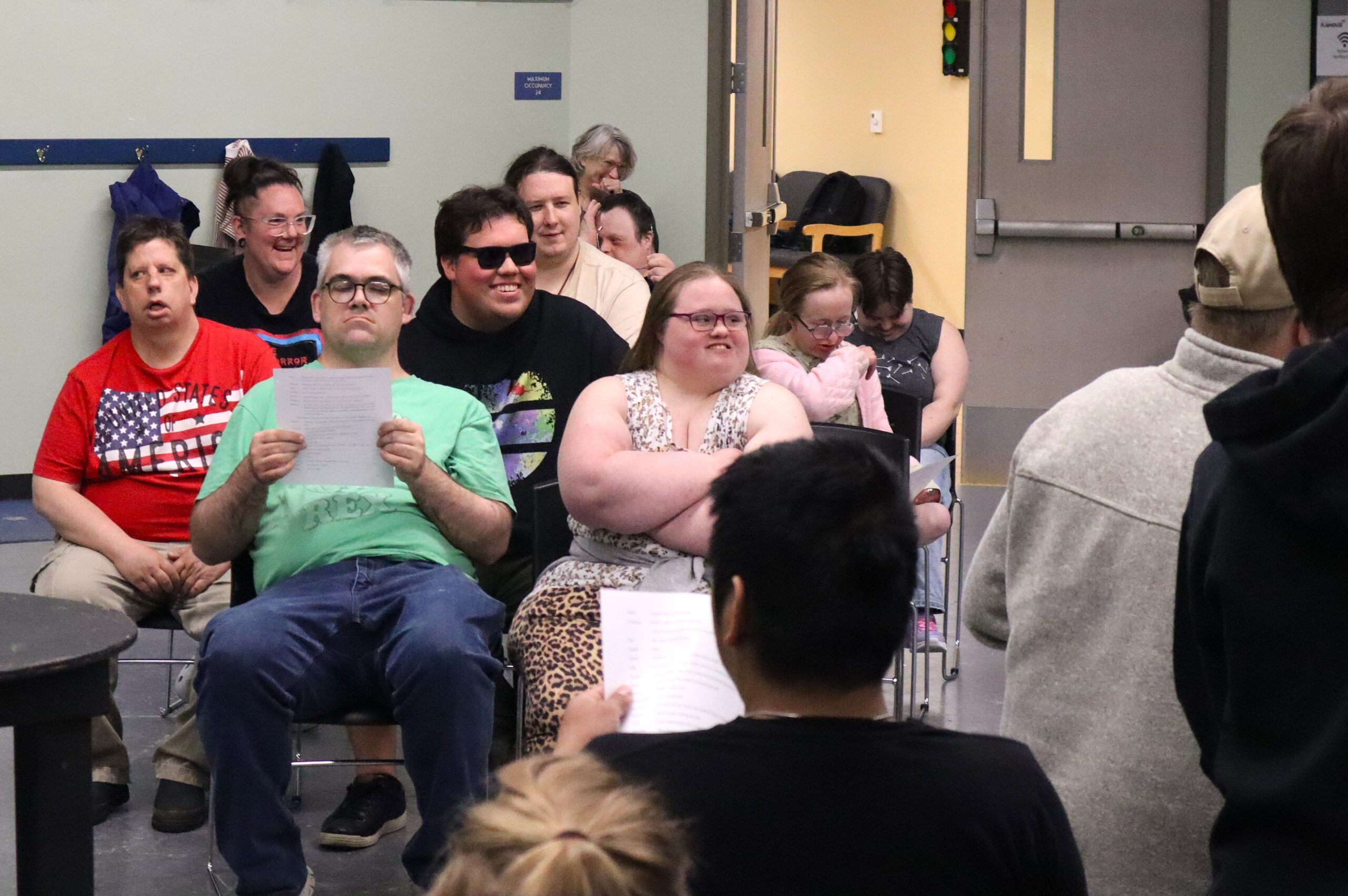 People sitting and looking at scripts.