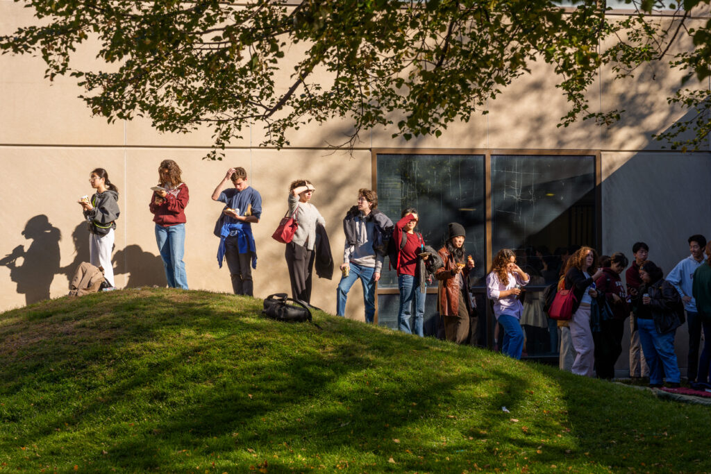 People waiting in line in an outdoor courtyard