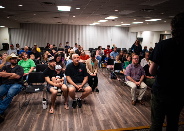 An audience sitting indoors.