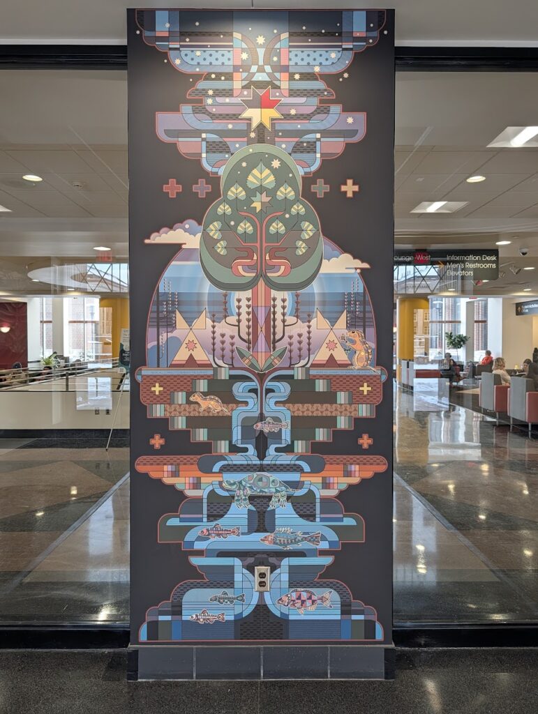 One colorful indoor art panel inside an entryway of a large building.