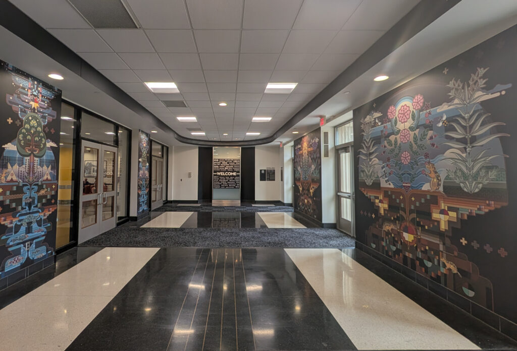 A black and white entryway with murals.