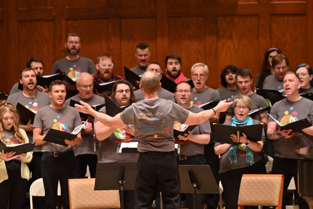 A choir director in front of a performing choir.